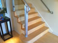 Stainless steel rail with glass between balusters