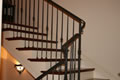 All iron on mill built Brazilian cherry straight to radius stair with mid-landing, Piedmont, CA