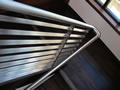 Stainless steel welded & grained matched railing system over closed walnut buttress scissor stair, Napa, CA